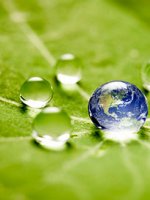 Die Erde in einem Wassertropfen auf einem grünen Blatt.
